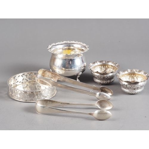 369 - Two pairs of silver sugar tongs, a pair of silver salts, a pierced coaster and a footed bowl, 7.7oz ... 