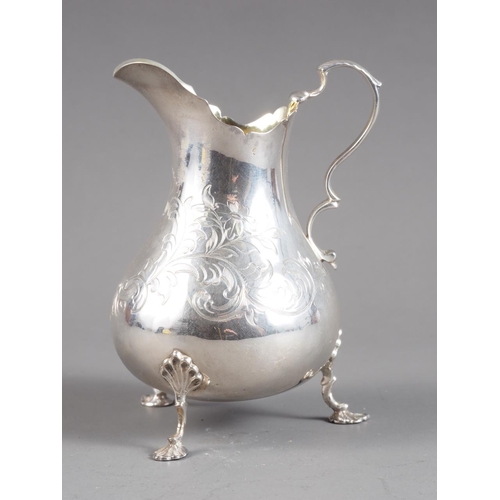 371 - A Victorian silver footed cream jug with engraved decoration, 3.7oz troy approx