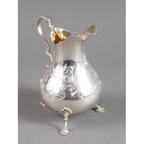 371 - A Victorian silver footed cream jug with engraved decoration, 3.7oz troy approx