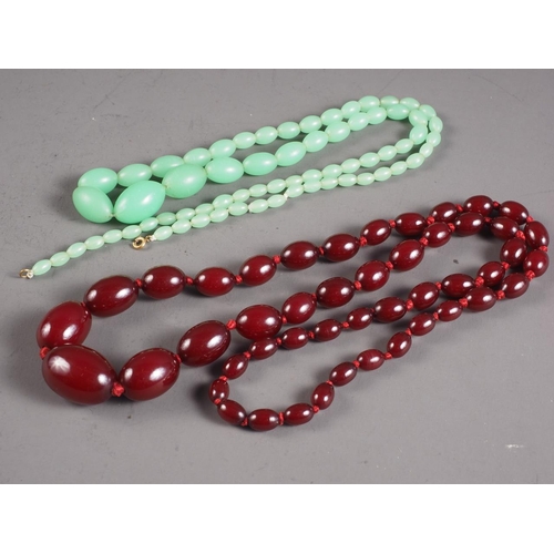 388 - A string of cherry amber Bakelite graduated oval beads, largest 29mm wide, 61g, and a jade coloured ... 