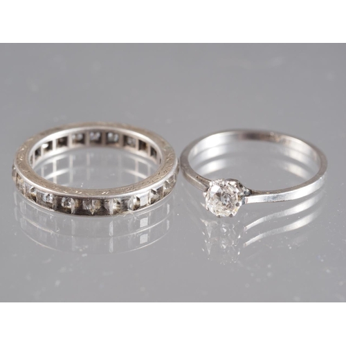 430 - A platinum and diamond solitaire ring, size N 1/2, 2.1g, and a similar white metal full eternity rin... 