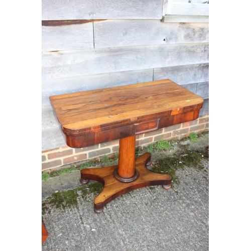 536 - A 19th century rosewood card table, on turned column, four shaped supports and bun feet, 36