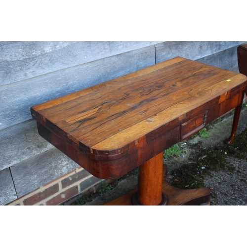 536 - A 19th century rosewood card table, on turned column, four shaped supports and bun feet, 36