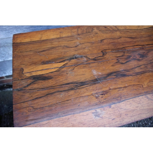 536 - A 19th century rosewood card table, on turned column, four shaped supports and bun feet, 36