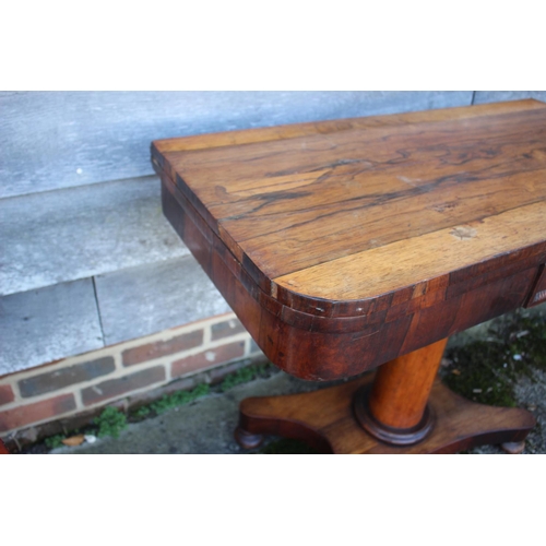 536 - A 19th century rosewood card table, on turned column, four shaped supports and bun feet, 36