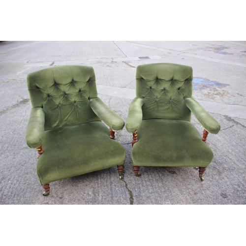 540 - A pair of Victorian oak framed armchairs, upholstered in a green velour, on turned and brass castore... 