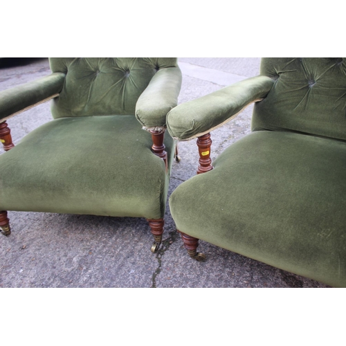 540 - A pair of Victorian oak framed armchairs, upholstered in a green velour, on turned and brass castore... 