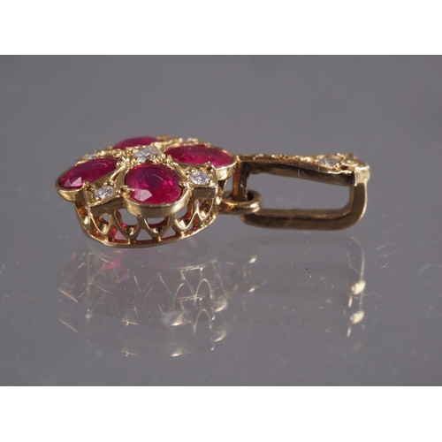 389 - A 9ct gold, diamond and ruby pendant, 1.1g