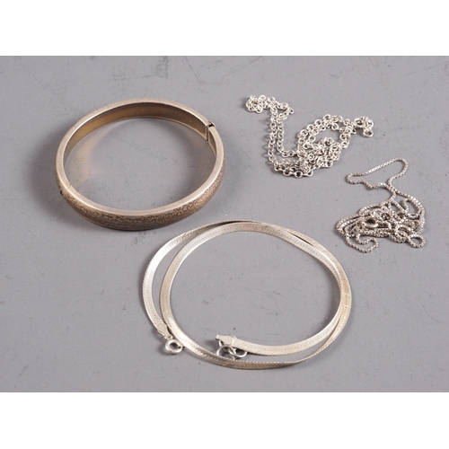 399 - Three silver necklaces and a silver bangle, 0.9oz troy approx