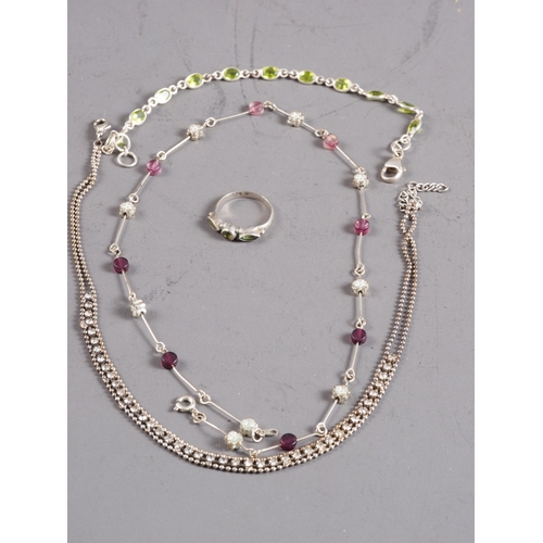 401 - A silver bracelet, set olivine, a similar ring and two white metal necklaces