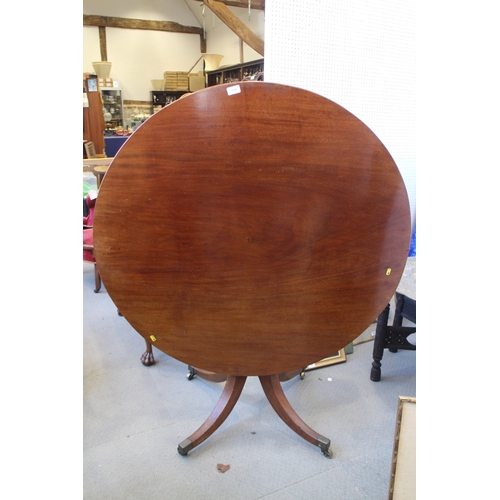 534 - A 19th century mahogany circular topped tilt top table, on quadruple splayed and castored supports, ... 