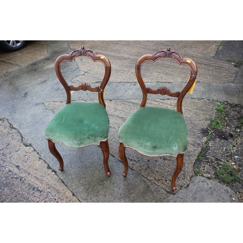 555 - A set of three French carved walnut side chairs with padded seats and backs, on cabriole supports an... 
