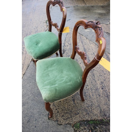 555 - A set of three French carved walnut side chairs with padded seats and backs, on cabriole supports an... 