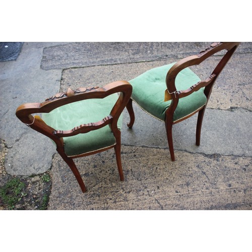 555 - A set of three French carved walnut side chairs with padded seats and backs, on cabriole supports an... 