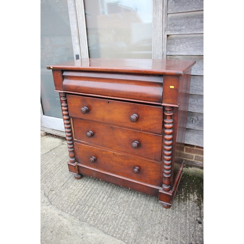 557 - A 19th century mahogany chest of four long graduated drawers with knob handles and bobbin turned spl... 