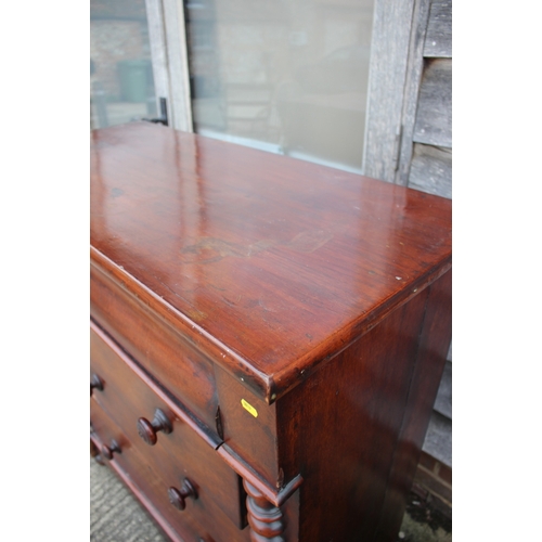 557 - A 19th century mahogany chest of four long graduated drawers with knob handles and bobbin turned spl... 