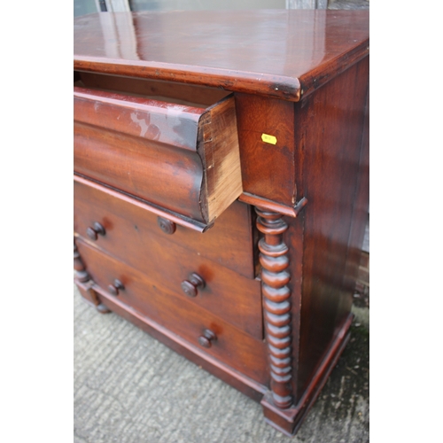 557 - A 19th century mahogany chest of four long graduated drawers with knob handles and bobbin turned spl... 