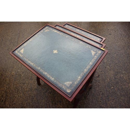 656 - A nest of three mahogany leather top x-frame occasional tables, largest 22
