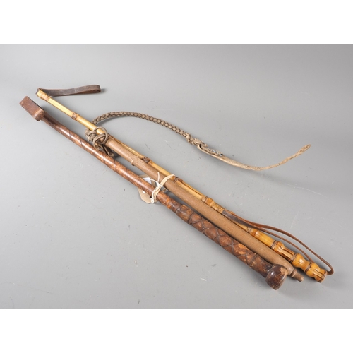 188 - A bamboo riding crop, 27&rdquo; long, a leather wrapped riding crop, 25&rdquo; long, and a similar s... 