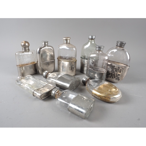 229 - Ten late 19th early 20th century hip flasks, one with cup engraved leaf decoration, tallest 6