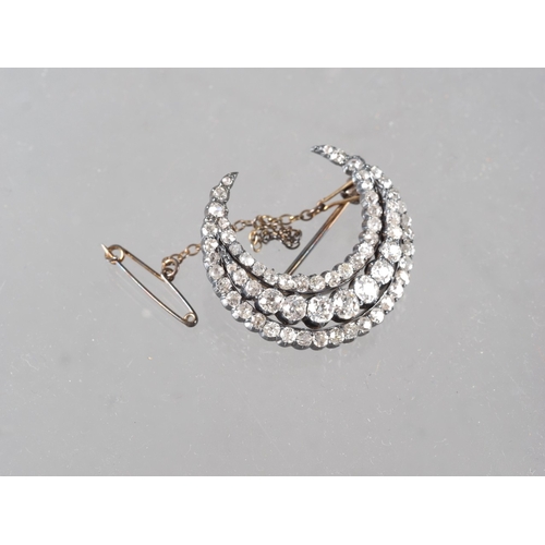 359 - A Victorian white metal and old cut diamond brooch formed as a crescent moon
