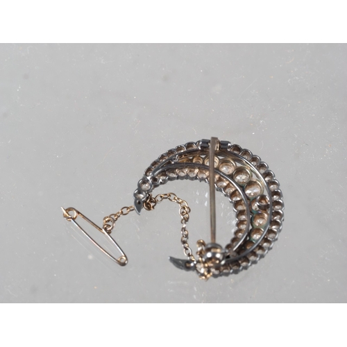 359 - A Victorian white metal and old cut diamond brooch formed as a crescent moon