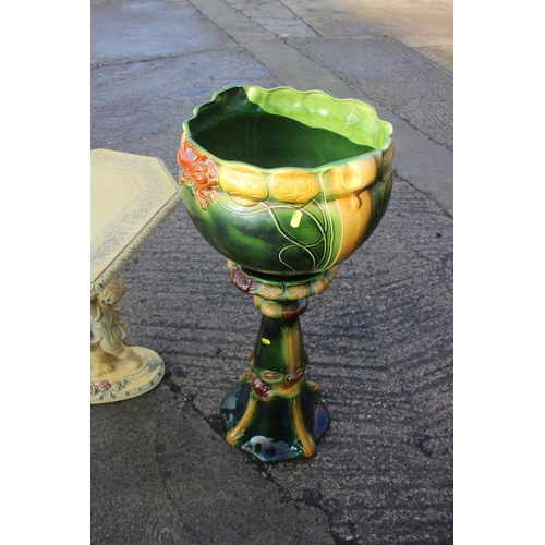 215 - A Victorian style green and cream glazed Majolica jardiniere on stand, 35