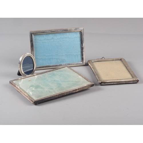 303 - A rectangular silver photograph frame, and three others