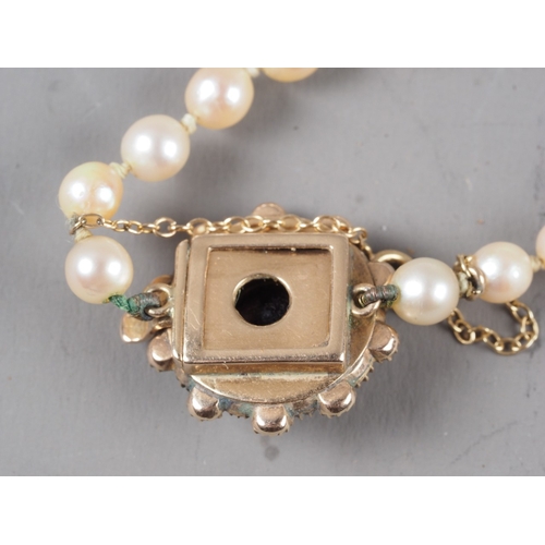329 - A late 19th century single strand graduated cultured pearl necklace, with yellow metal, amethyst and... 