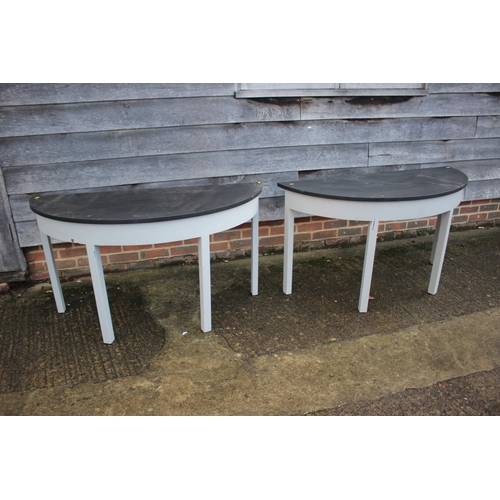 591 - A pair of grey painted and black top semicircular console tables, on square taper supports, 50