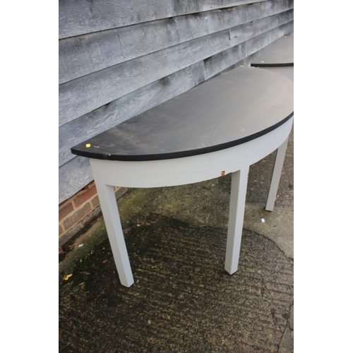 591 - A pair of grey painted and black top semicircular console tables, on square taper supports, 50