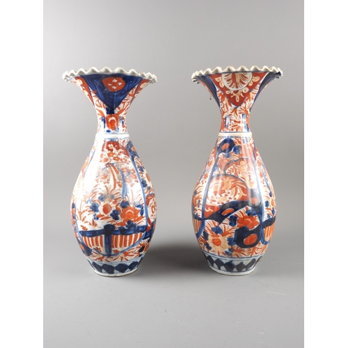 93 - A pair of Japanese flared rim ovoid vases with floral decoration, 15 1/4&rdquo; high (damages)
