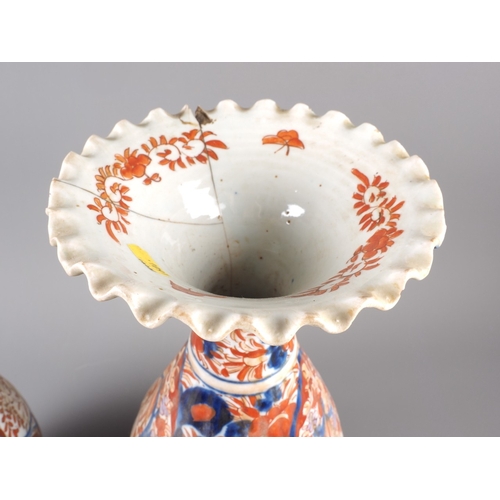 93 - A pair of Japanese flared rim ovoid vases with floral decoration, 15 1/4&rdquo; high (damages)
