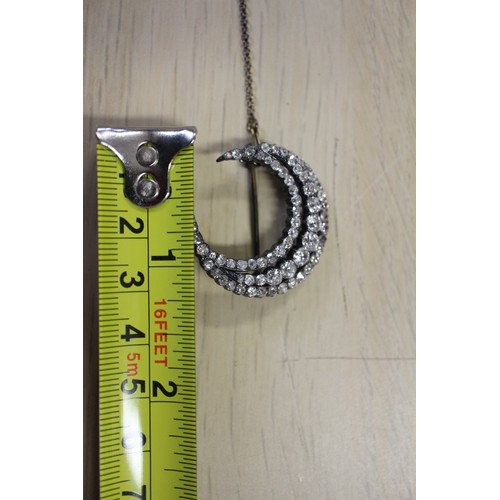 359 - A Victorian white metal and old cut diamond brooch formed as a crescent moon
