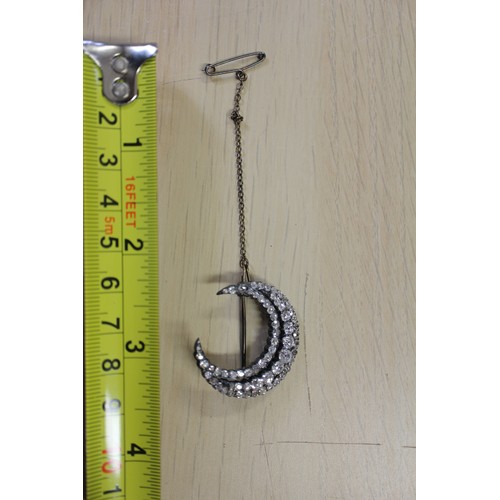 359 - A Victorian white metal and old cut diamond brooch formed as a crescent moon