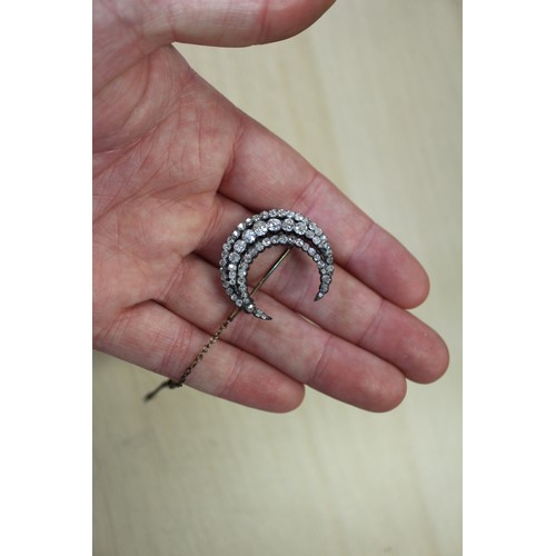 359 - A Victorian white metal and old cut diamond brooch formed as a crescent moon