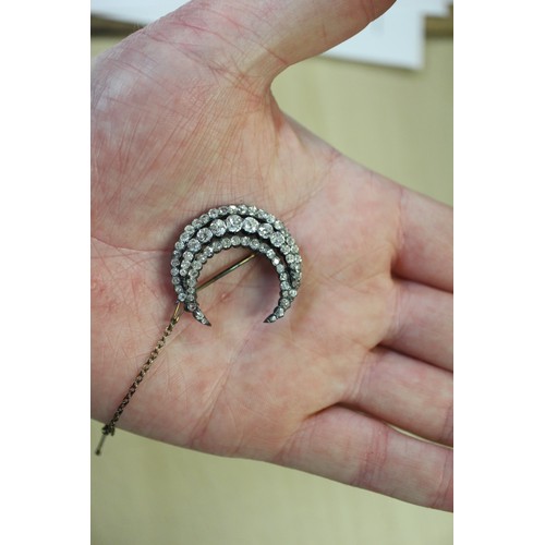 359 - A Victorian white metal and old cut diamond brooch formed as a crescent moon