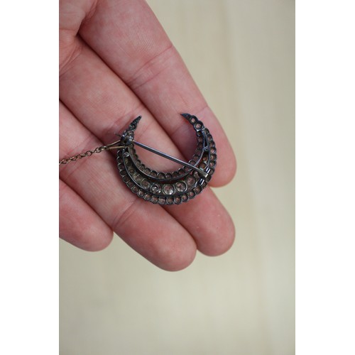 359 - A Victorian white metal and old cut diamond brooch formed as a crescent moon