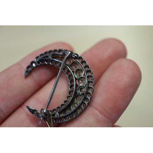 359 - A Victorian white metal and old cut diamond brooch formed as a crescent moon