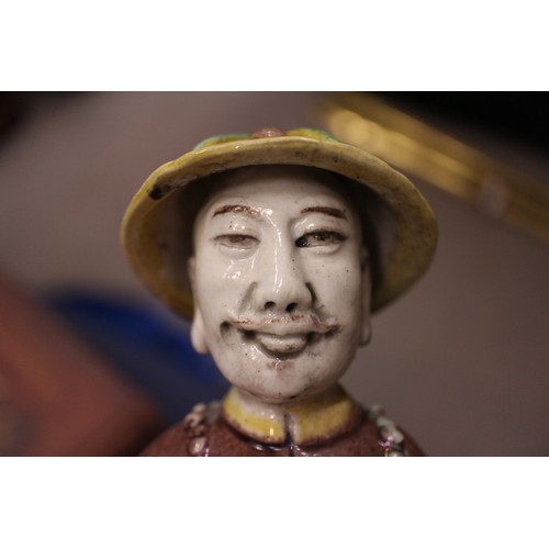 83 - A set of three Chinese yellow, green and brown glazed figures, with stamped marks to bases, 11