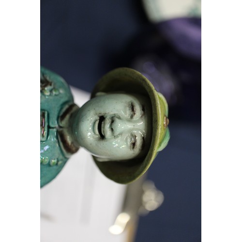 83 - A set of three Chinese yellow, green and brown glazed figures, with stamped marks to bases, 11