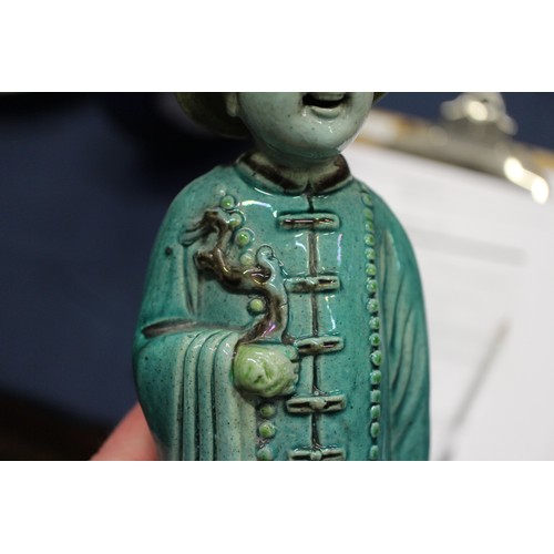 83 - A set of three Chinese yellow, green and brown glazed figures, with stamped marks to bases, 11
