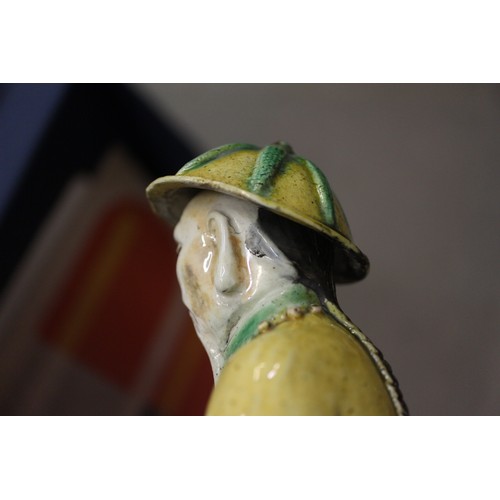 83 - A set of three Chinese yellow, green and brown glazed figures, with stamped marks to bases, 11