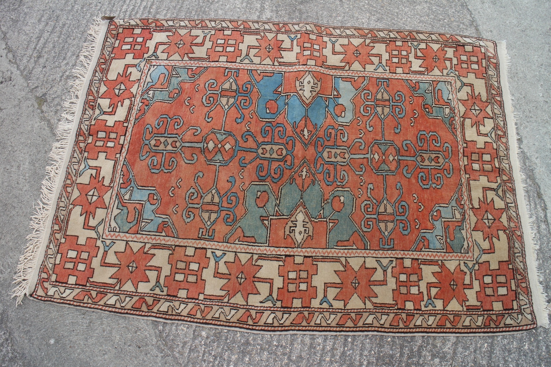 A modern Kazakh rug with all floral geometric design, on a rust ground ...