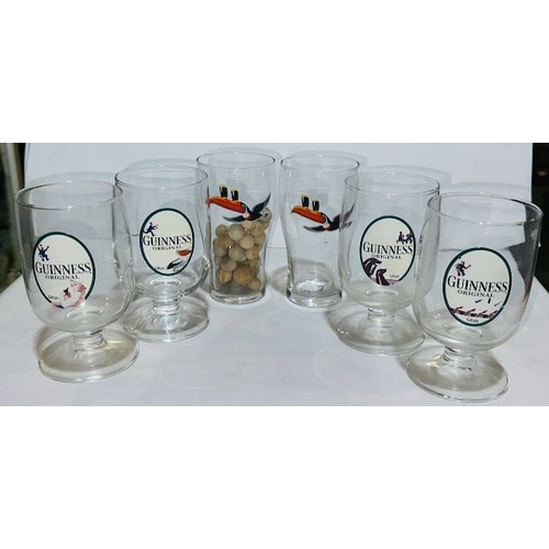 7 - 4 Gilroy Footed Guinness Glasses Plus 2 Toucan Half Pint Glasses, One Containing Marbles