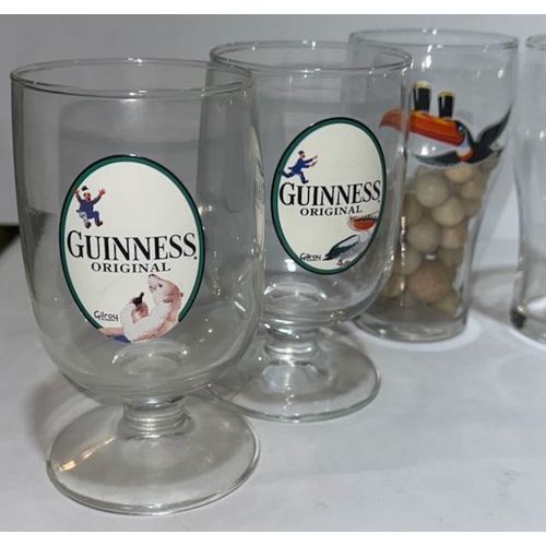 7 - 4 Gilroy Footed Guinness Glasses Plus 2 Toucan Half Pint Glasses, One Containing Marbles