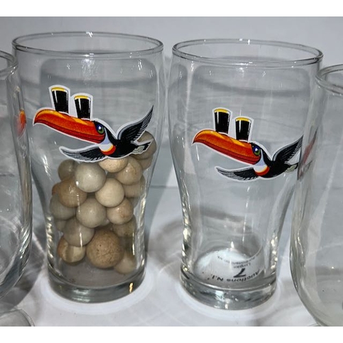 7 - 4 Gilroy Footed Guinness Glasses Plus 2 Toucan Half Pint Glasses, One Containing Marbles