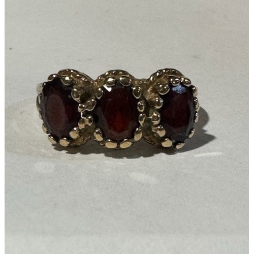 322 - 9ct Gold Garnet Triliogy Ring