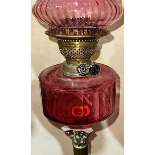 219 - Antique Brass Column Based Oil Lamp with Cranberry Glass Reservoir, Young's Burner & Cranberry Glass... 