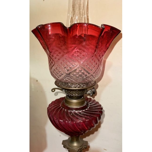 429 - Antique Brass Corinthian Based Oil Lamp with Ornate Ruby Glass Reservoir & Ruby Fluted Shade